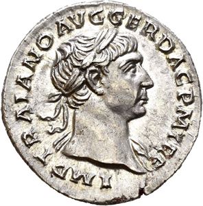 Trajan. AD 98-117. AR denarius, Roma AD 107, (3,43 g). Laureate head of Trajan right / COS V P P S P Q R OPTIMO PRINC, Victory standing left, holding wreath and palm branch. Almost as struck and lustrous. Some red residue on edge.