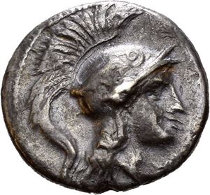 LUCANIA, The Lucani. Circa 280-278 BC. AR drachm, (2,98 g). Struck on the reduced Tarentine standard. Helmeted head of Athena left / Barley grain with leaf to right; club above leaf. Obverse struck with worn die. Small edge mark and punch marks on reverse. Attractive deep iridescent cabinet toning. Rare.