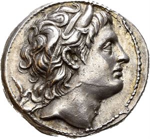 KINGS OF MACEDON, Demetrios I Poliorketes (306/5-283 BC). AR tetradrachm (17,13 g). Struck in Pella 291-290 BC. Horned and diademed head of Demetrios to right / BA&Sigma;I&Lambda;E&Omega;&Sigma; &Delta;HMHTPIOY, Nude Poseidon Pelagaios standing left with right foot on rock, holding trident in left hand and resting right arm on leg; Monogram in right and left field. Small die break on obverse and light doubling on reverse. Nicely toned. Rare issue.