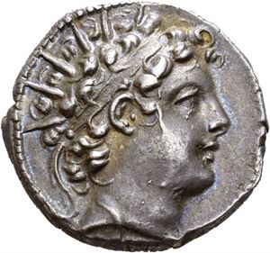 SELEUKID KINGS of SYRIA. Antiochos VI Dionysos (145-142/1 BC). AR drachm (4,21 g). Apameia on the Axios mint. Dated SE 168 (=145/4 BC). Radiate and diademed head of Antiochos VI to right / BASI?EOS ANTIOXOY ???F????S ?????S?Y, Apollo seated left on omphalos, holding arrow in right hand and grounded bow in left hand; palm branch in outer left field; monogram between legs; H?P (date) followed by STA in exergue. Reverse struck a little off centre. Good metal and wonderful iridescent toning.