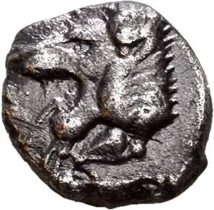 CARIA, uncertain. Circa 450 BC. AR obol (0,58 g). Forepart of roaring lion to right / Facing panther's head within incuse square. Darkly toned