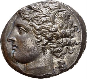 SICILY, Syracuse. 214-212 BC. AR 8 litrai (6,61 g). Reverse die signed by the artist Lysid and struck under the Romans circa 212 BC. Head of Persephone to left, wreathed with grain; owl to right / &Sigma;YPAKO&Sigma;I&Omega;N, Nike driving fast quadriga to right; Magistrate name AI to right; faint artist signature AY on exergue line. Irregular flan and reverse struck a bit off-centre. Wonderful style and nicely toned with areas of blue iridescence. Very rare.
