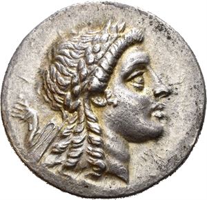 AEOLIS, Myrina. Circa 160-143 BC. AR tetradrachm (16,68 g). Stephanophoric type. Laureate head of Apollo to right / MYPINAION, Apollo Grynios standing right, holding branch and phiale; monogram to outer left; omphalos and amphora in front of feet to right; all within laurel wreath. Well struck and with an appealing light iridescent toning.
