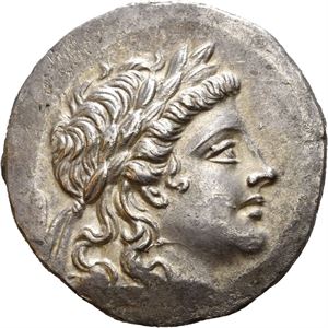 AEOLIS, Myrina. Circa 160-143 BC. AR tetradrachm (16,22 g). Stephanophoric type. Laureate head of Apollo to right / MYPINAI&Omega;N, Apollo Grynios standing right, holding branch and phiale; omphalos and amphora in front of feet to right; all within laurel wreath. Some areas of flat strike and very faint cleaning scratches in fields. Light iridescent toning.