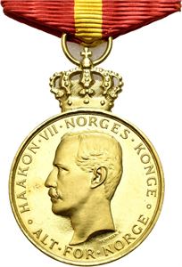 Haakon VII. Kongens fortjenstmedalje. Gull med krone, hempe og bånd. 28 mm. I original eske